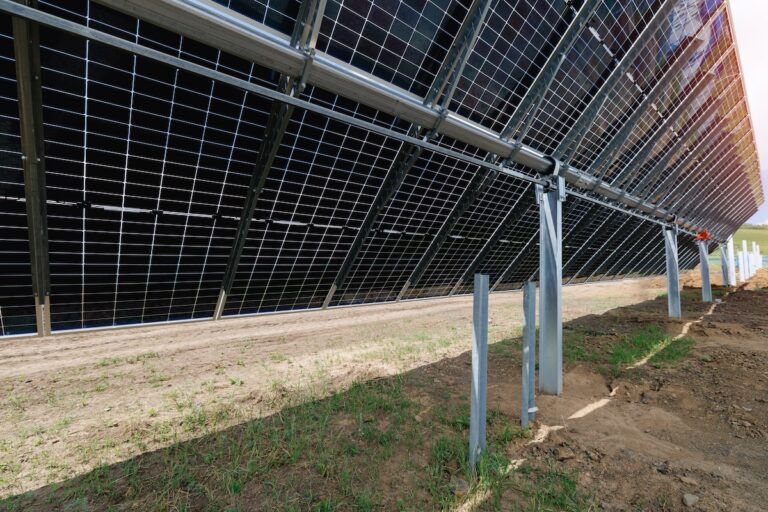 Solar panel support structure with metal beams and red mounting bracket.