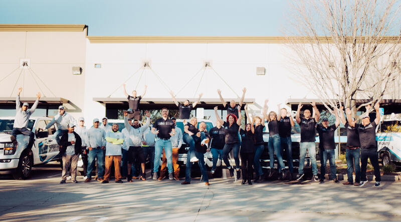 Spartan crew celebrating roof repair warranty work in California