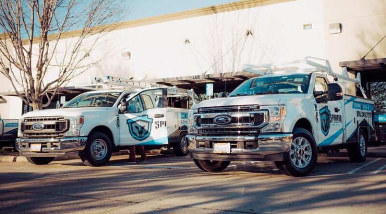 Spartan work trucks at the office for roof repair warranty in California